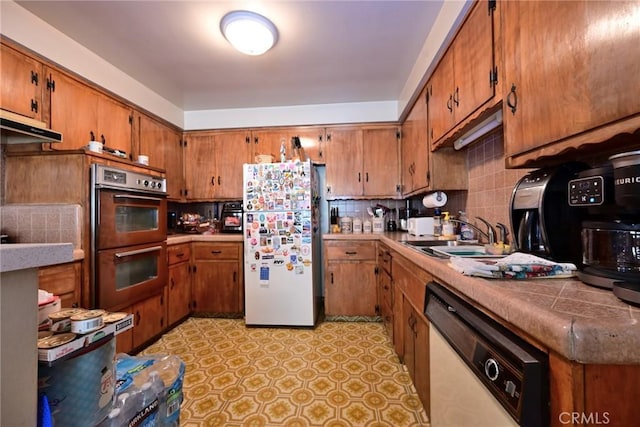 428 N Garfield Ave, Alhambra, CA 91801 - kitchen with white appliances, brown cabinets, and a sink
