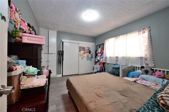 428 N Garfield Ave, Alhambra, CA 91801 - bedroom with a closet, a textured ceiling, and wood finished floors