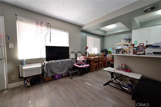 428 N Garfield Ave, Alhambra, CA 91801 - interior space featuring an AC wall unit, visible vents, a textured ceiling, and wood finished floors