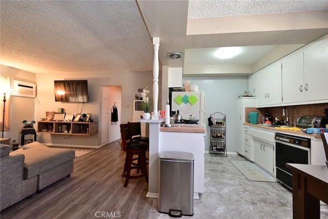 428 N Garfield Ave, Alhambra, CA 91801 - kitchen with dishwasher, a breakfast bar, freestanding refrigerator, ornate columns, and a wall mounted AC
