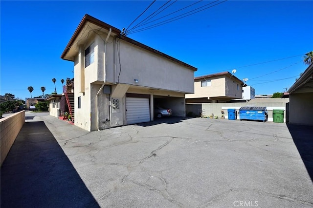 428 N Garfield Ave, Alhambra, CA 91801 - view of property exterior featuring a garage, fence, and stucco siding