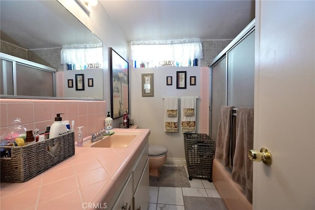 428 N Garfield Ave, Alhambra, CA 91801 - full bathroom with enclosed tub / shower combo, tile patterned flooring, toilet, vanity, and decorative backsplash