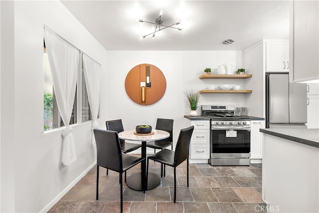 dining room featuring stone finish flooring, visible vents, and baseboards