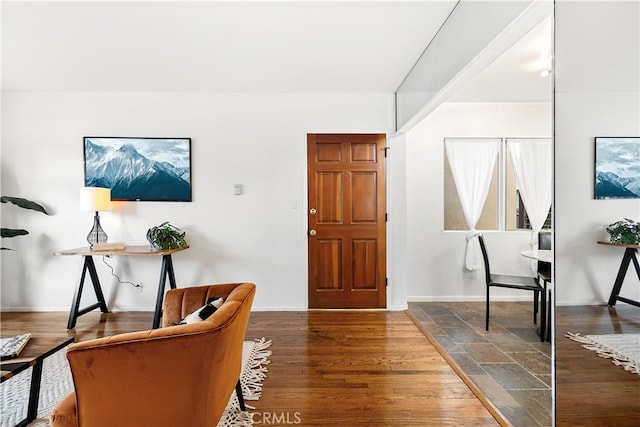 entryway with baseboards and wood finished floors