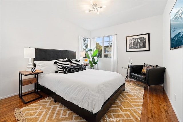 bedroom with light wood-style flooring and baseboards