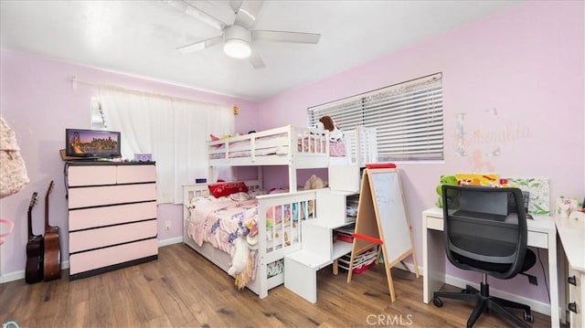 bedroom with wood finished floors, baseboards, and ceiling fan