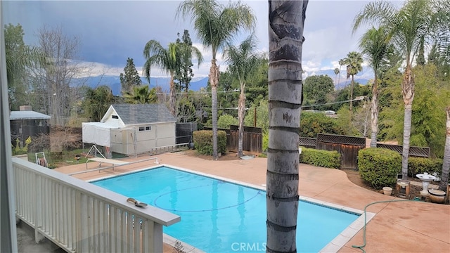 view of pool featuring a fenced in pool, a patio, an outdoor structure, and fence