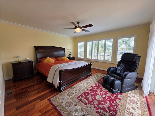 bedroom with dark wood-style floors, visible vents, crown molding, and baseboards