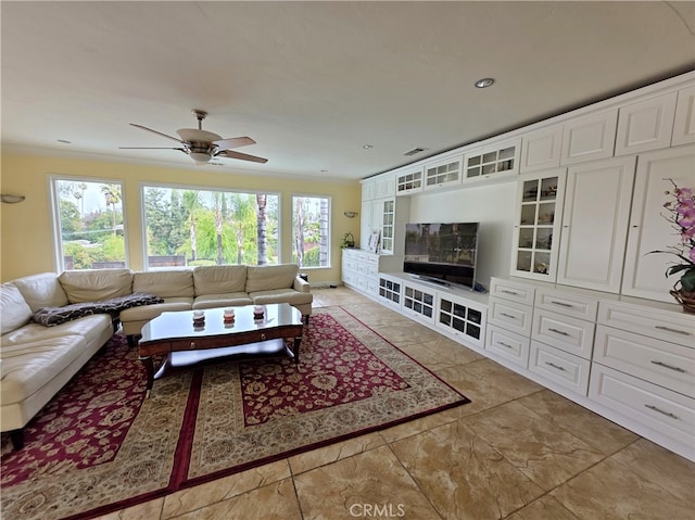 living area featuring crown molding and ceiling fan