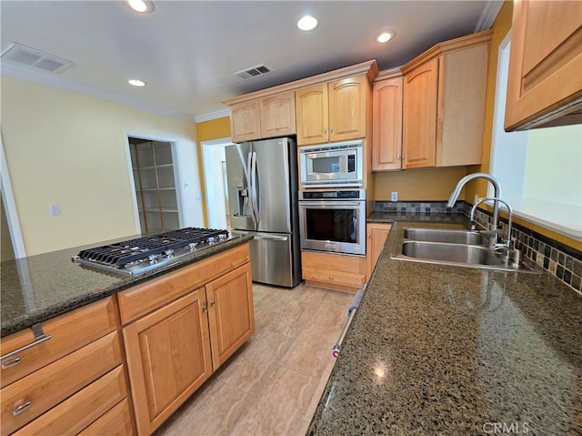 kitchen with crown molding, visible vents, appliances with stainless steel finishes, and a sink