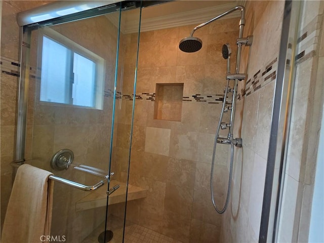 full bath with a shower stall and crown molding