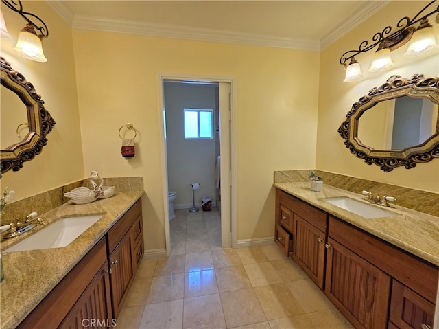 full bathroom with toilet, ornamental molding, and a sink