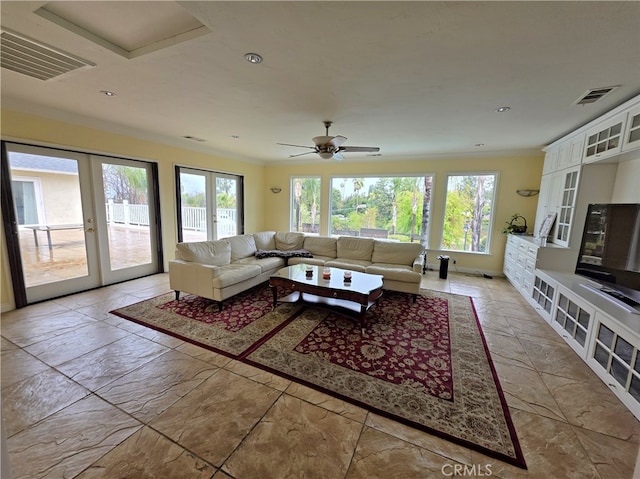 living room with french doors, visible vents, and crown molding