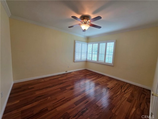 empty room featuring baseboards, dark wood-style floors, and ornamental molding