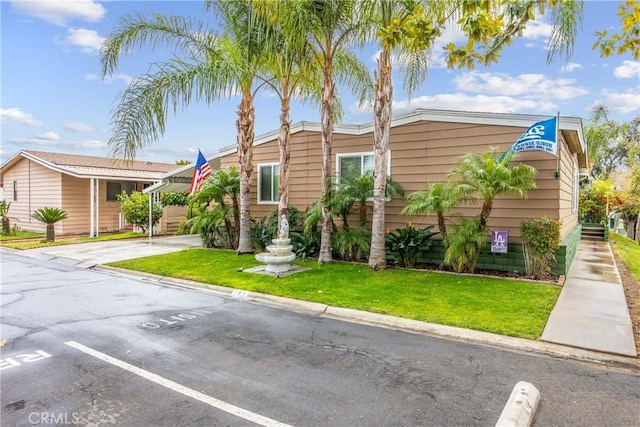 929 E Foothill Unit 161, Upland, CA 91786 - view of front facade featuring uncovered parking and a front lawn