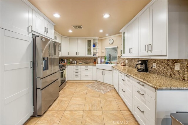 929 E Foothill Unit 161, Upland, CA 91786 - kitchen featuring a sink, visible vents, appliances with stainless steel finishes, backsplash, and glass insert cabinets