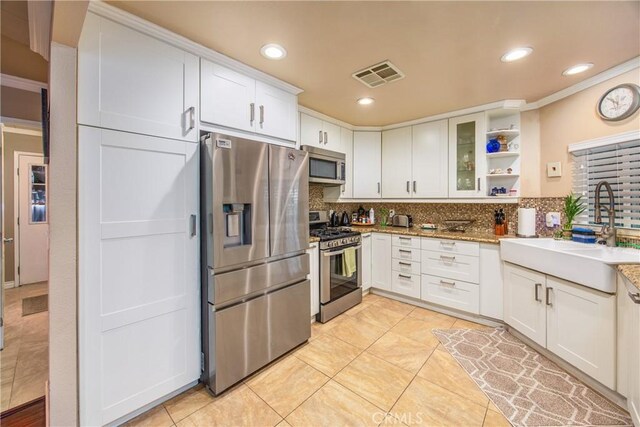 929 E Foothill Unit 161, Upland, CA 91786 - kitchen featuring tasteful backsplash, visible vents, stainless steel appliances, white cabinetry, and a sink