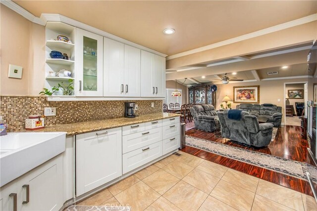 929 E Foothill Unit 161, Upland, CA 91786 - kitchen featuring a ceiling fan, white cabinets, and ornamental molding