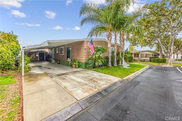 929 E Foothill Unit 161, Upland, CA 91786 - view of front of home with uncovered parking, a carport, and a front yard