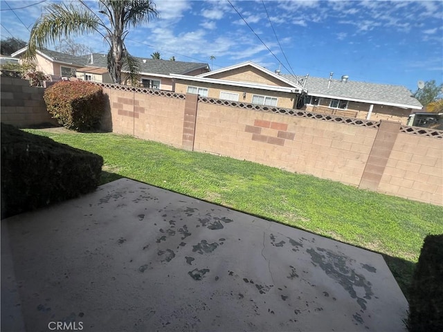 view of yard featuring a patio and fence