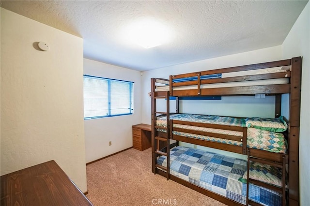 bedroom featuring carpet floors and a textured ceiling