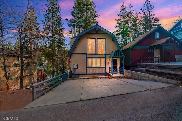 view of front of home featuring fence and a gambrel roof