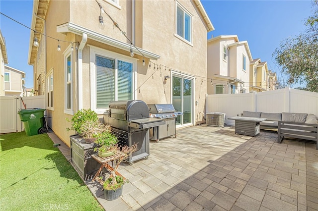 view of patio / terrace featuring area for grilling, a fenced backyard, and an outdoor hangout area