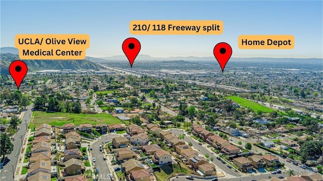 birds eye view of property featuring a mountain view and a residential view