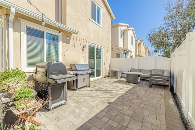 view of patio with area for grilling, a fenced backyard, and outdoor lounge area