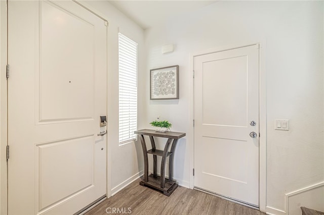 entrance foyer with baseboards and light wood finished floors