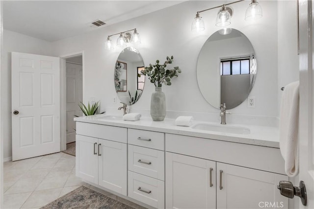 full bathroom featuring double vanity, tile patterned flooring, a sink, and visible vents