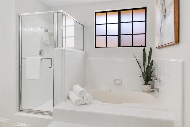 full bath with a garden tub and a shower stall