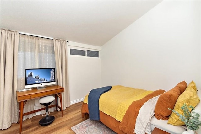 bedroom featuring baseboards and wood finished floors