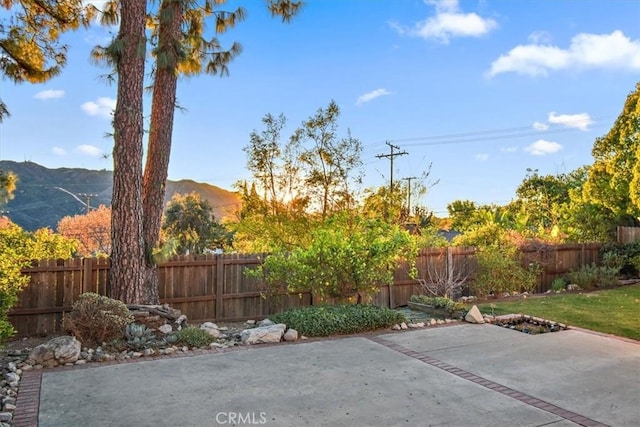 view of patio featuring a fenced backyard and a mountain view