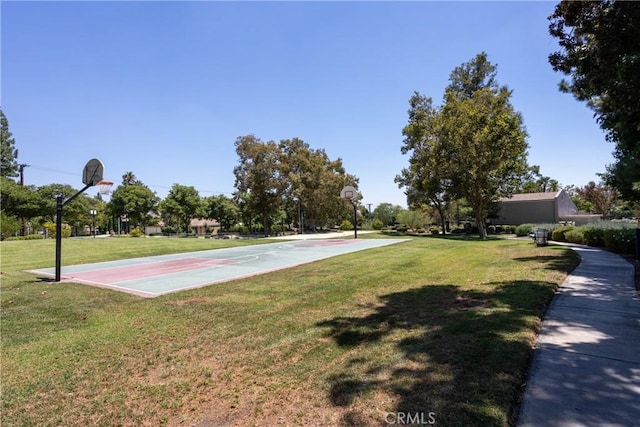 view of sport court featuring a yard and community basketball court