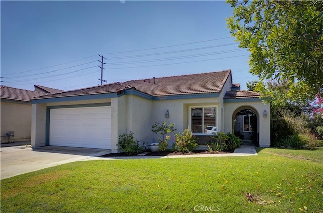 view of front of property featuring a garage, concrete driveway, a tiled roof, a front yard, and stucco siding