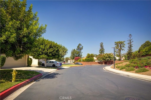 view of street with curbs