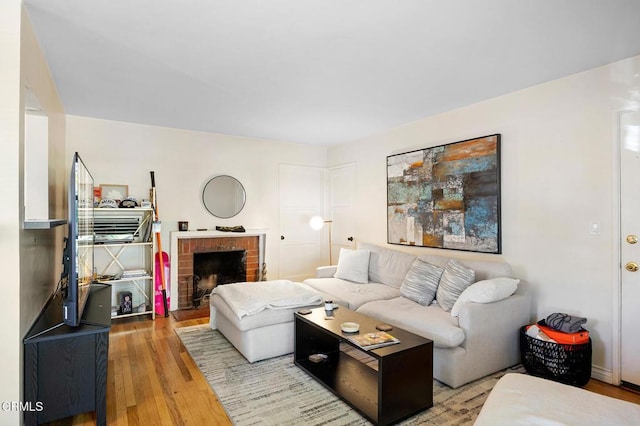 living room with a fireplace and wood finished floors