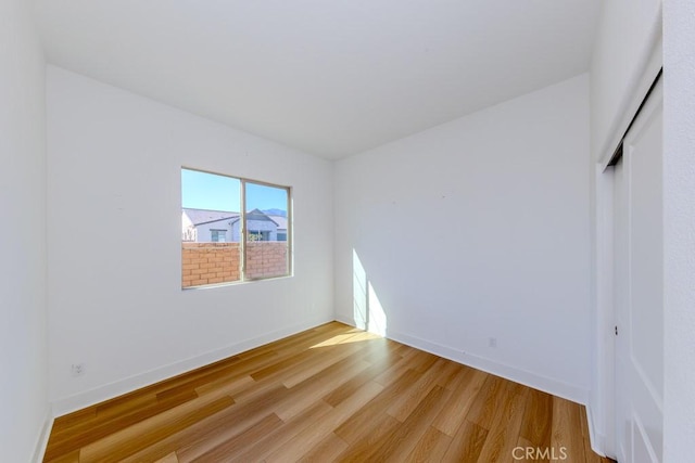 unfurnished bedroom featuring light wood-style floors and baseboards