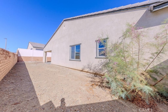 view of home's exterior with a fenced backyard and stucco siding