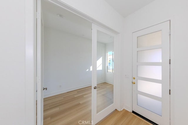 entrance foyer featuring light wood-style flooring and baseboards