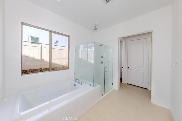 bathroom featuring a garden tub, a shower stall, visible vents, and baseboards