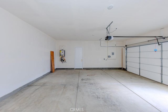 garage featuring a garage door opener, water heater, and baseboards