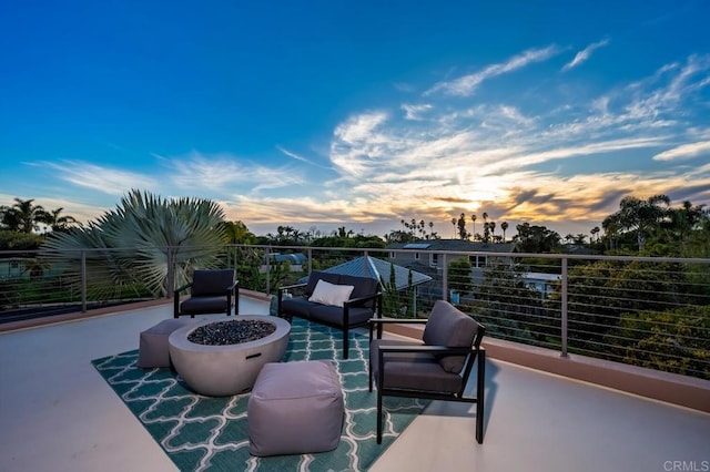 view of patio / terrace featuring a fire pit and a balcony