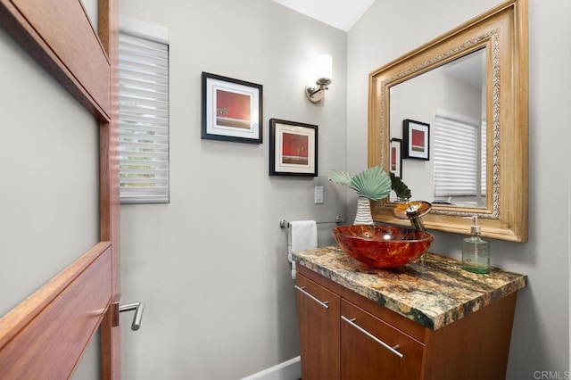 bathroom with vanity and baseboards
