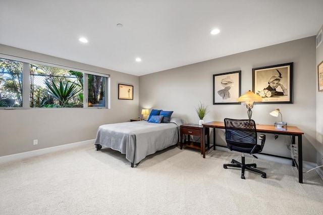 bedroom with light colored carpet, recessed lighting, and baseboards