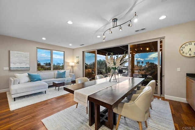 dining room with visible vents, baseboards, and wood finished floors