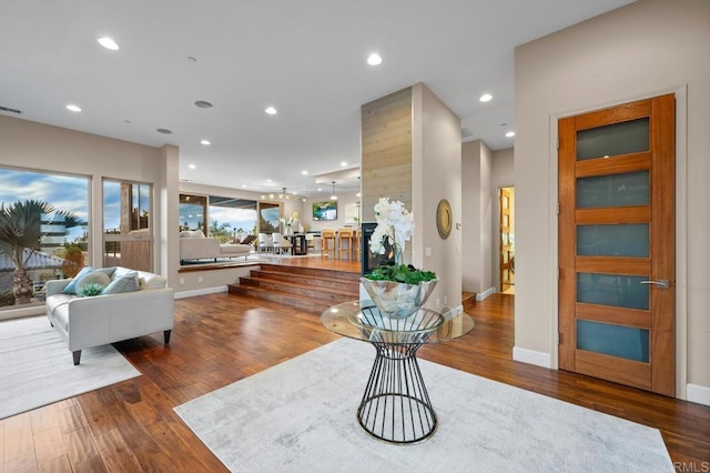 foyer entrance with recessed lighting, baseboards, visible vents, and wood finished floors