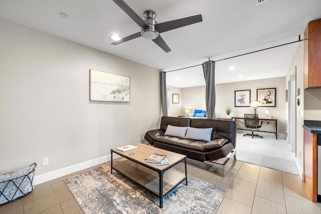 living room featuring a ceiling fan, baseboards, and recessed lighting
