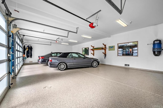 garage with baseboards and a garage door opener